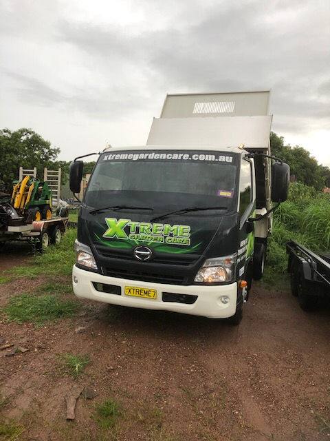 Xtreme Garden Care truck and crane parked on site before a tree job in Darwin